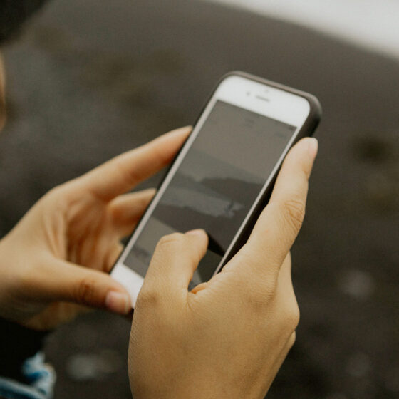 Woman holding white iPhone