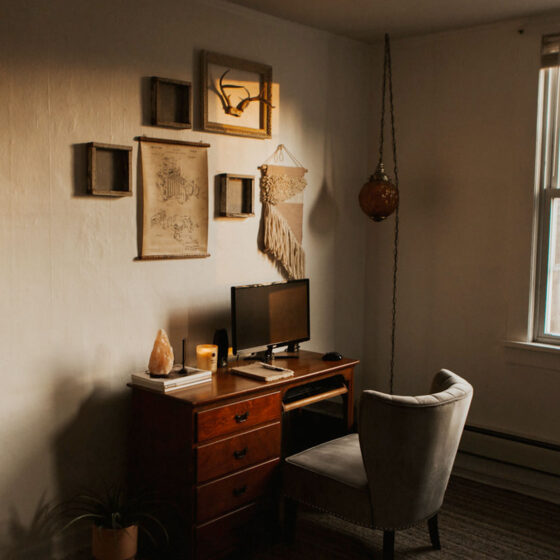 Sunlight shining on a desk and decorated wall