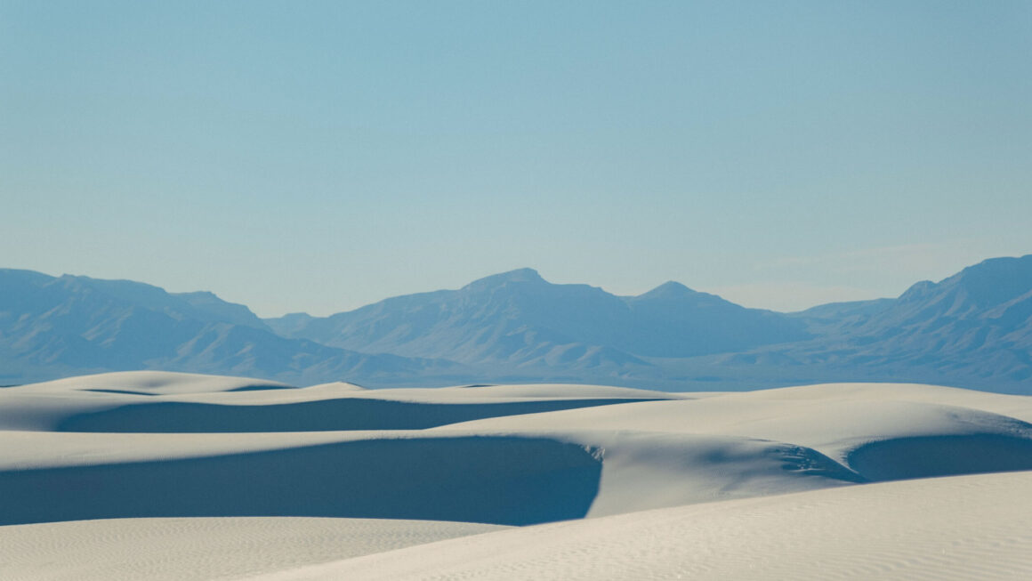 Desert sand with mountains in the background