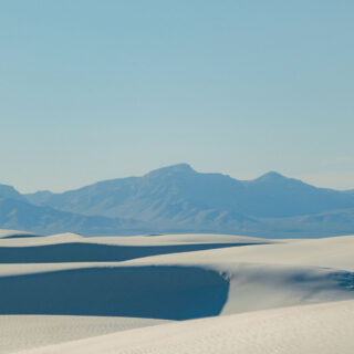 Desert sand with mountains in the background
