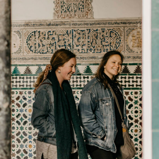 Two girls walking next to Turkish building