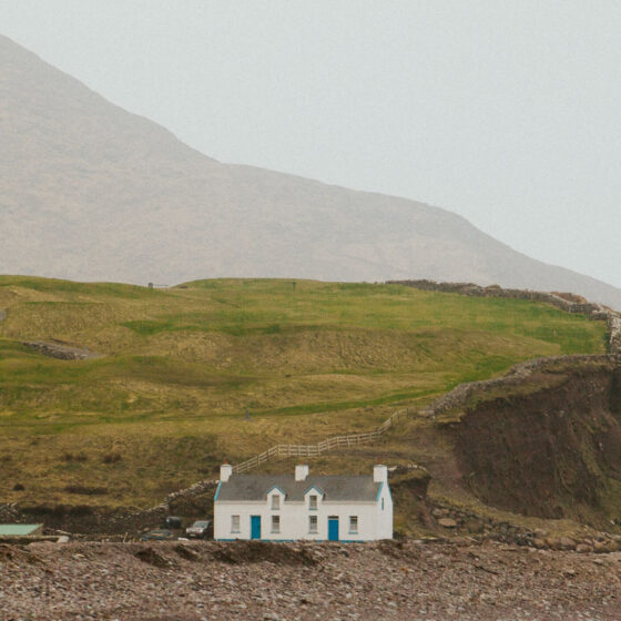 Home with large cliff and mountain in the background