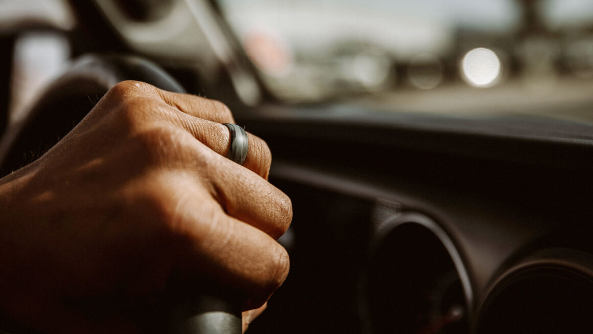 Close-up of hand on steering wheel