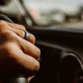 Close-up of hand on steering wheel