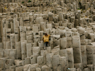 Girl climbing large rock formations