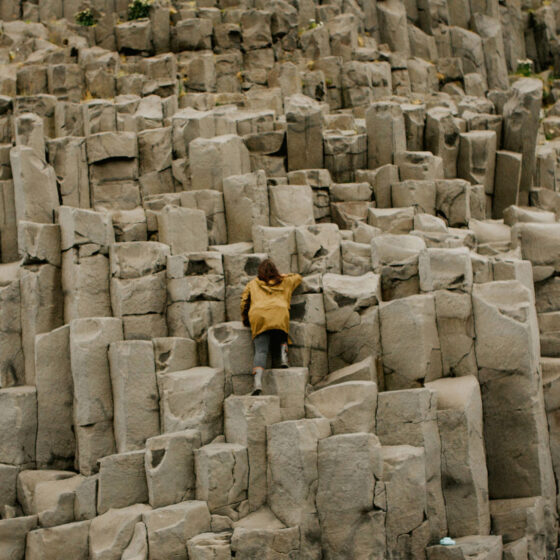 Girl climbing large rock formations