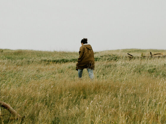 Woman walking through tall grass