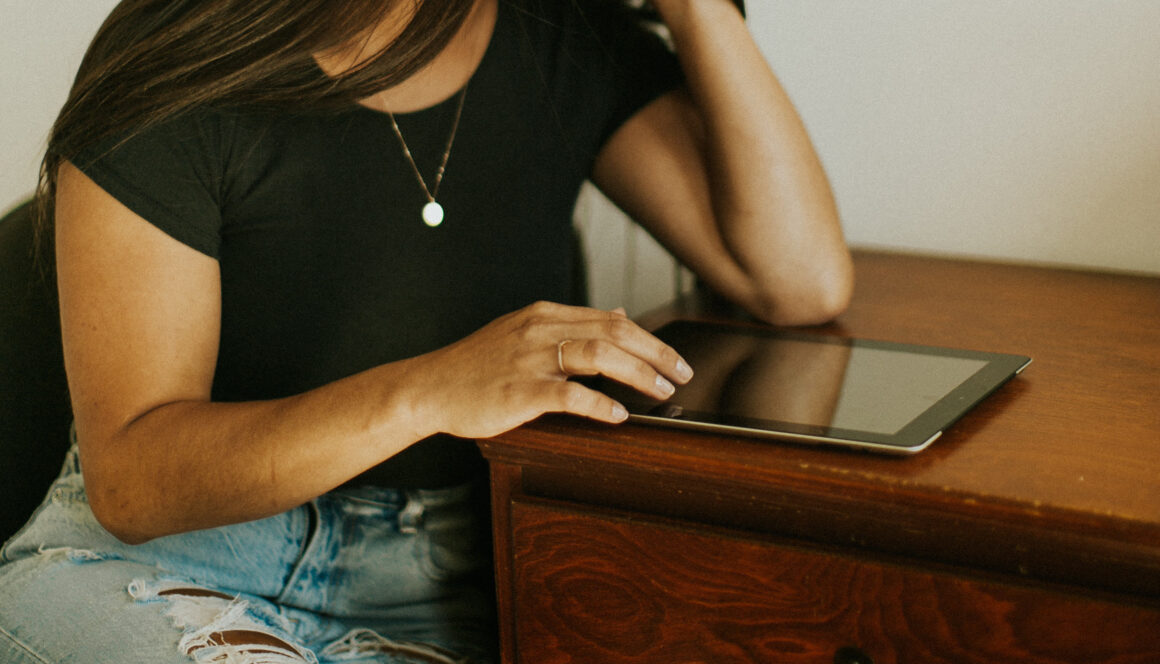 Woman with iPad on a desk