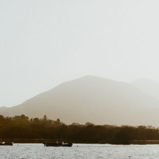 Boats on lake with with mountains in the background