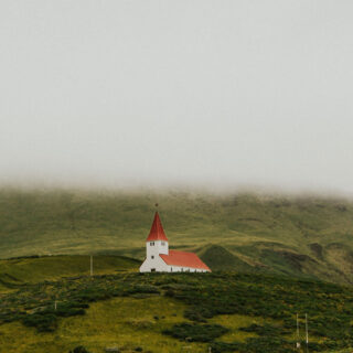 White church on a green hill