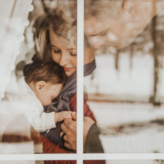 Mother and father holding a young baby